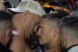 Heavyweight title contenders Tyson Fury and Oleksandr Usyk had a feisty face-off at the weigh-in. (AP PHOTO)